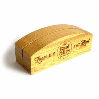 POS bamboo block with The Real Olive Company branding on it and the words 'Love Life Eat Real.