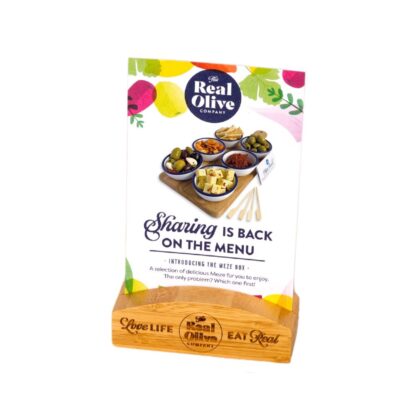 A Real Olive Company meze table talker for the meze board displayed in a branded bamboo meze point of sale block.