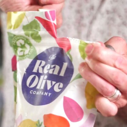 A 1kg foodservice resealable pouch being opened ready to pour into meze bowls or recyclable tubs.